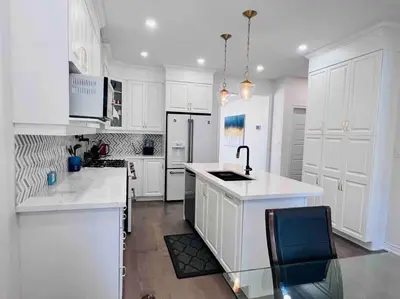 a white kitchen with white cabinets and a sink at Luxury Oakville Home, Hot Tub, Fireplace, New Home in Oakville