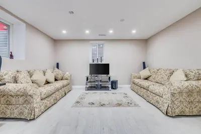 a living room with two couches and a tv at Hidden Gem: Spacious Basement in Milton