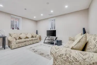 a living room with two couches and a tv at Hidden Gem: Spacious Basement in Milton