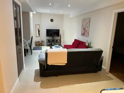 a living room with a couch and a tv at 2 bedroom basement with parking in Richmond Hill