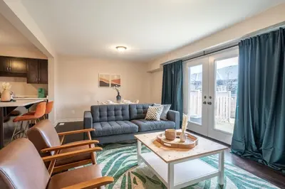 a living room with a couch and a table at 6min To Niagara Falls - 4 Free Parking - Foosball in Niagara Falls