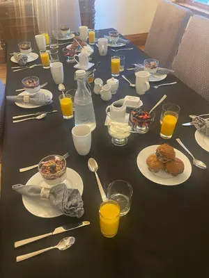 a table with plates of food and glasses of orange juice at North of Avon B&B Suites in Stratford