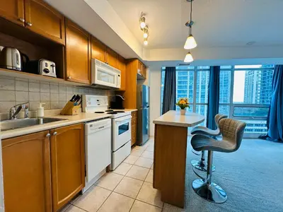 a kitchen with a desk and a chair in it at RivetStays - The Yonge in Toronto