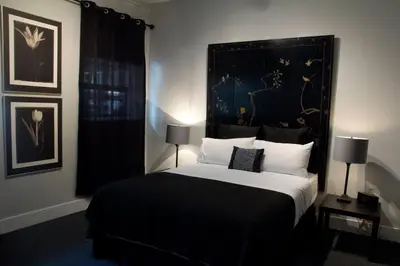 a bedroom with a large bed with a black headboard at Woodbine Warehouse Apartment in Toronto