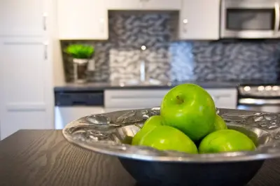 a bowl of green apples on a table in a kitchen at Woodbine Warehouse Apartment in Toronto