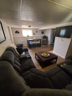 a living room with a couch and a table at Serenity Place by the Lake in Brighton