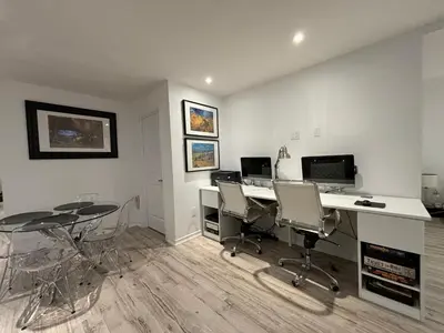 an office with two desks and chairs and a computer at Luxury Executive Studio in Oakville