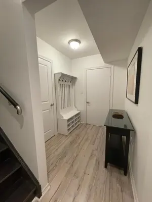 an empty living room with a table and stairs at Luxury Executive Studio in Oakville