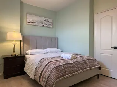a bedroom with a bed with a towel on it at Luxury Spacious 5-Bedroom Home in London