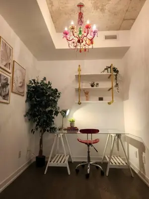 a room with a table and two chairs and a chandelier at Chic 1BDR Loft with Office Space-Heart of Toronto in Toronto