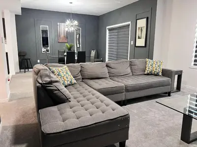 a living room with a couch and a table at Spacious 4-Bedroom Home, Comfortably Sleeps 10 in Barrie