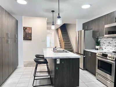 a kitchen with a sink and a counter top at Spacious 4-Bedroom Home, Comfortably Sleeps 10 in Barrie