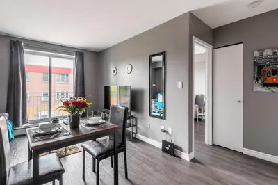 a dining room with a table and chairs in a room at Glenview West Apartment w Patio - Near Downtown in Hamilton