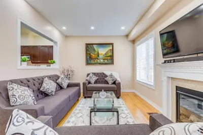a living room with a couch and a fireplace at Avid vacation palace in Castlemore , Brampton in Brampton