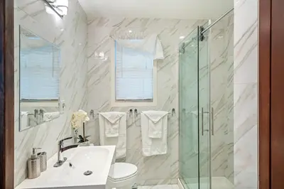 a bathroom with a sink and a shower at Vineyard Villa in Niagara on the Lake