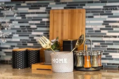 a kitchen counter with some utensils in buckets at 4br Near Hilton Falls - Kelso - Gazebo, Workspace in Milton