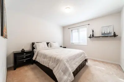 a bedroom with a large bed and a window at 4br Near Hilton Falls - Kelso - Gazebo, Workspace in Milton