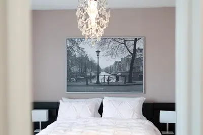 a bedroom with a bed with a chandelier above it at 4br Near Hilton Falls - Kelso - Gazebo, Workspace in Milton