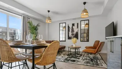 a dining room with a table and chairs at 2br Boho Townhouse - Walk To Falls, Free Parking in Niagara Falls
