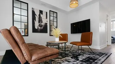 a living room with a couch and two chairs at 2br Boho Townhouse - Walk To Falls, Free Parking in Niagara Falls