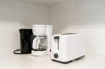 a coffee maker and a toaster on a counter at 2br - Spacious Yard - Canal Bridge, Falls Nearby! in Welland