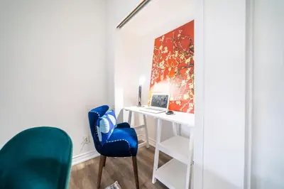 a room with a desk and a blue chair at 2br - Spacious Yard - Canal Bridge, Falls Nearby! in Welland