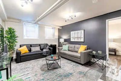 a living room with two couches and a table at Modern Apartment in a Trendy Neighbourhood in Hamilton