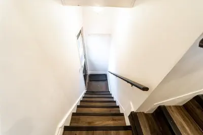 a stairway with white walls and wooden floors at 2br, Welland Canal, Near Merritt, 20 Min To Falls in Welland