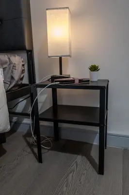 a black desk with a lamp and a plant on it at SHORE VISTA LODGE in Georgina