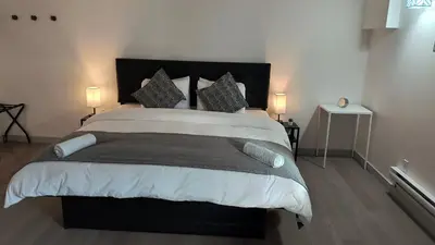 a bedroom with a large bed with two lamps at SHORE VISTA LODGE in Georgina
