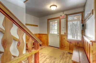 a room with a staircase and a door with a window at 8 bdrm Blue Mountain Cottage, Large Groups, Private Beach Access, Hot Tub, Sauna, Ping Pong Table Perfect for Large Groups, Petfriendly in Blue Mountains