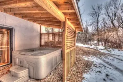 a hot tub in a building with a wooden roof at 8 bdrm Blue Mountain Cottage, Large Groups, Private Beach Access, Hot Tub, Sauna, Ping Pong Table Perfect for Large Groups, Petfriendly in Blue Mountains