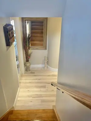 a hallway with a wooden floor and a window at Khan’s Resort in Cobourg
