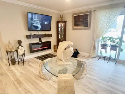 a living room with a flat screen tv and statues at Khan’s Resort in Cobourg