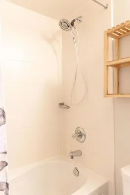 a bath tub with a shower in a bathroom at DWTN Condo Near CN Tower! w/ Free Parking in Toronto