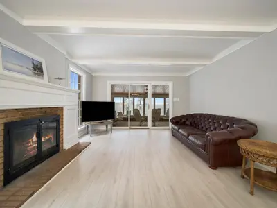 a living room with a couch and a fireplace at The Captains Lake House in Orillia