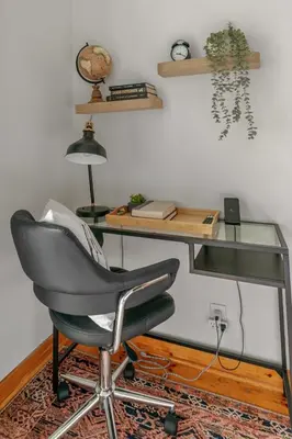 a desk with a chair and a glass table at Historic Victorian with Deck and Parking in Toronto