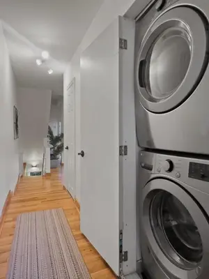 a laundry room with a washer and dryer at Historic Victorian with Deck and Parking in Toronto