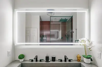 a bathroom with a sink with a large mirror at Historic Victorian with Deck and Parking in Toronto