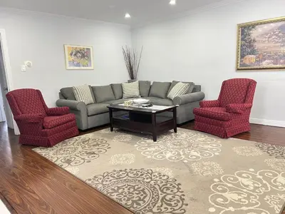 a living room with a couch and two chairs at 3 BR GREAT HOUSE WITH ONE parking in Richmond Hill