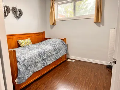 a bedroom with a bed and a window at 3 BR GREAT HOUSE WITH ONE parking in Richmond Hill