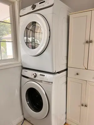 a washer and dryer in a kitchen with a window at 3 BR GREAT HOUSE WITH ONE parking in Richmond Hill