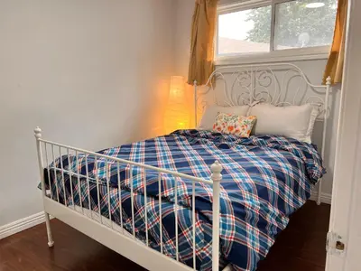 a white crib in a room with a window at 3 BR GREAT HOUSE WITH ONE parking in Richmond Hill