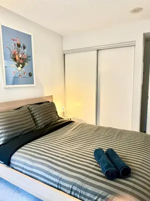 a bedroom with a bed with two pillows on it at Lush Condo By CNTower - Free Parking in Toronto