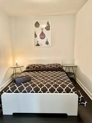 a bedroom with a bed and two side tables at Lush Condo By CNTower - Free Parking in Toronto