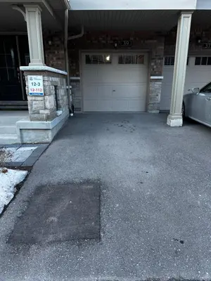 a garage with a car parked in front of it at Cozy Whitby Retreat in Whitby