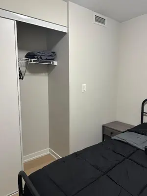 a bedroom with a bed and a closet at Downtown 2 bedroom Gem with Free Parking in Toronto