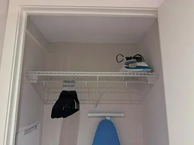 a shelf in a closet with a sewing machine on it at Downtown 2 bedroom Gem with Free Parking in Toronto