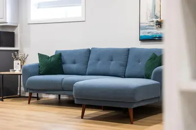 a blue couch in a living room with a table at Urban Haven: 2BR/2BA+Office, Kitchen, Dining in Newcastle