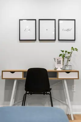 a black chair sitting in front of a desk at Urban Haven: 2BR/2BA+Office, Kitchen, Dining in Newcastle